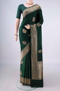 Bottle Green Banarasi Saree with Zari Butta on the body and Zari Border.  displayed on a mannequin