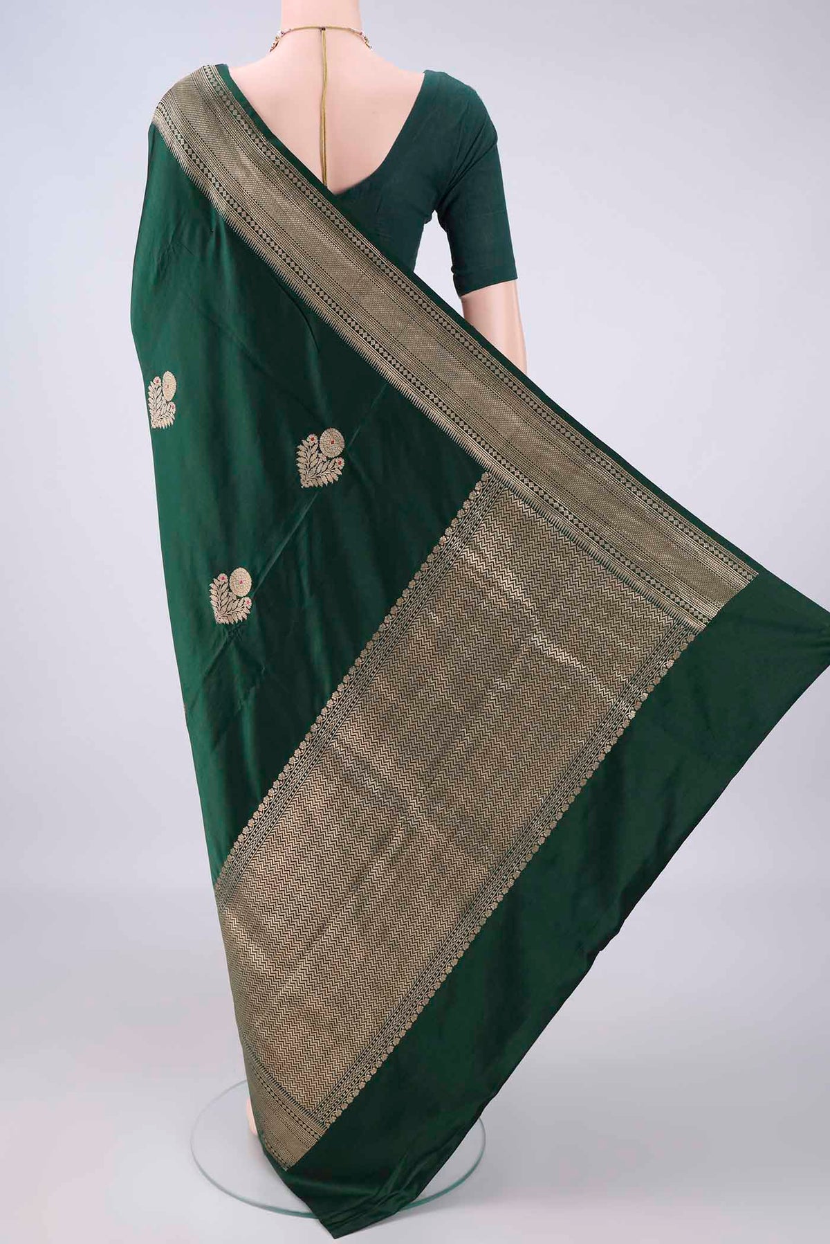 Flat view of Bottle Green Banarasi Saree with Zari Butta on the body and Zari Border. 