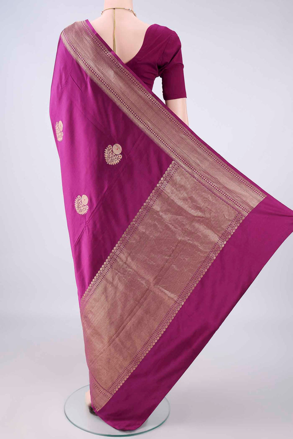 Flat view of Magenta Banarasi Saree with Zari Butta on the body and Zari Border. 