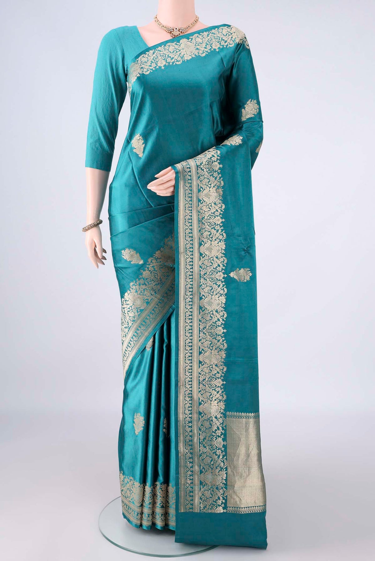 Sea Green Banarasi Saree with Zari Butta on the body and Zari Border.  displayed on a mannequin