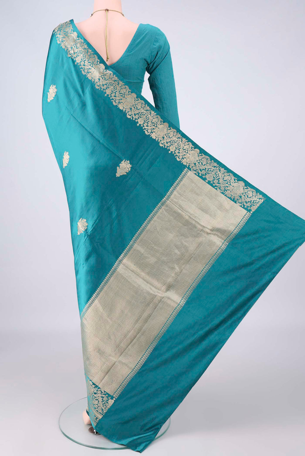 Flat view of Sea Green Banarasi Saree with Zari Butta on the body and Zari Border. 