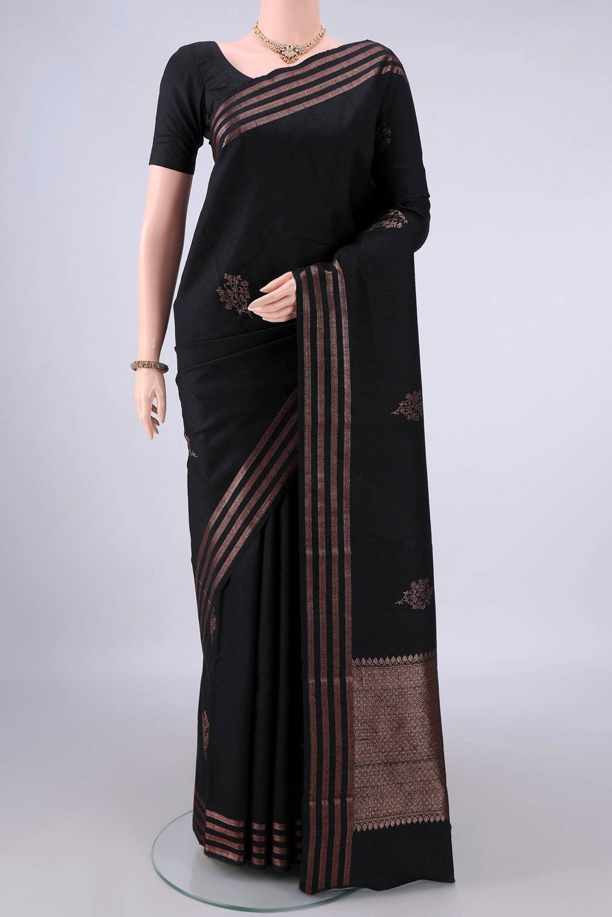 Black Banarasi Tussar Saree with Zari Butta on the body and Zari Border.  displayed on a mannequin
