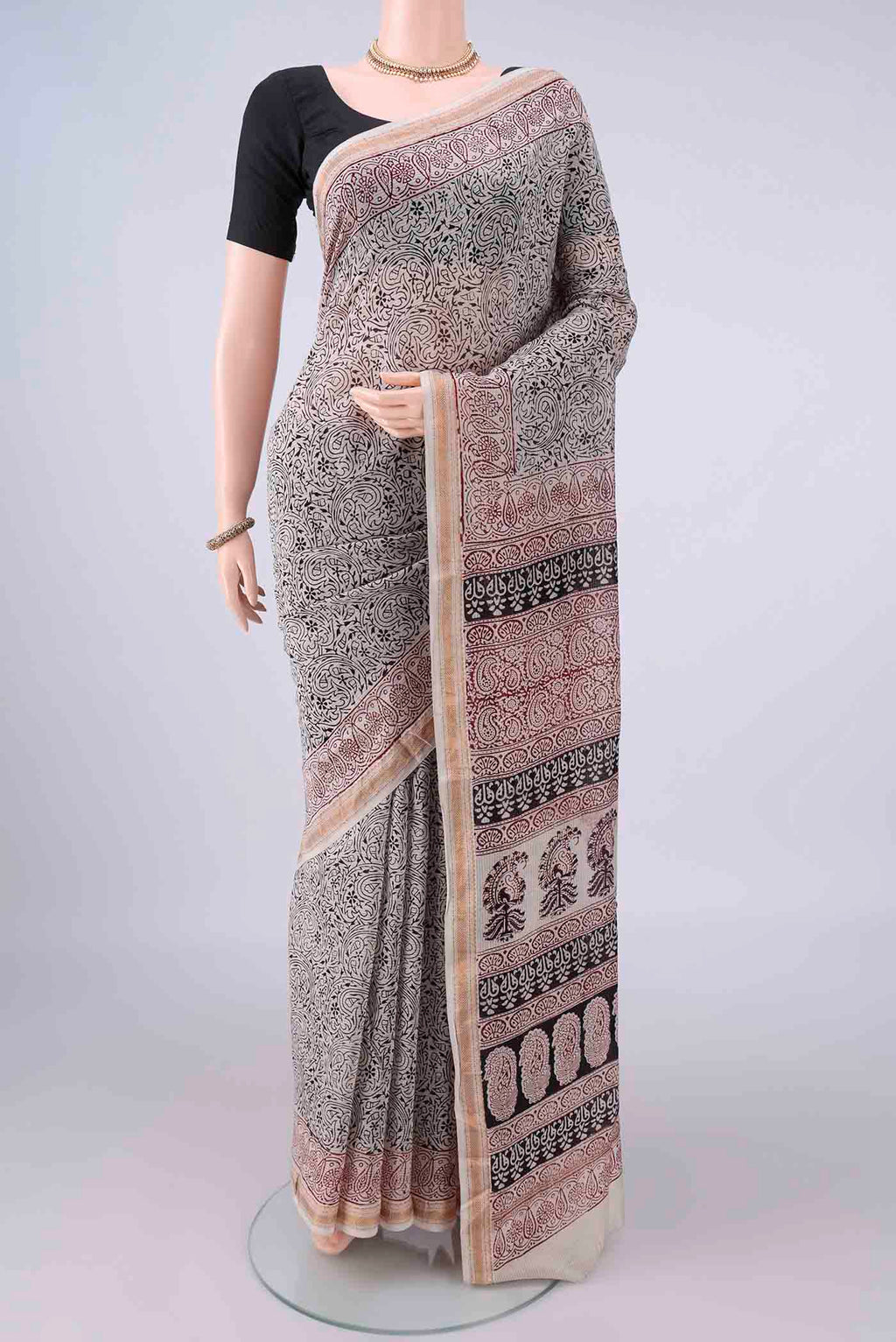 Cream Maheshwari Cotton Saree with Printed design on the body and Zari Border.  displayed on a mannequin