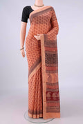 Peach Maheshwari Cotton Saree with Printed design on the body and Zari Border.  displayed on a mannequin