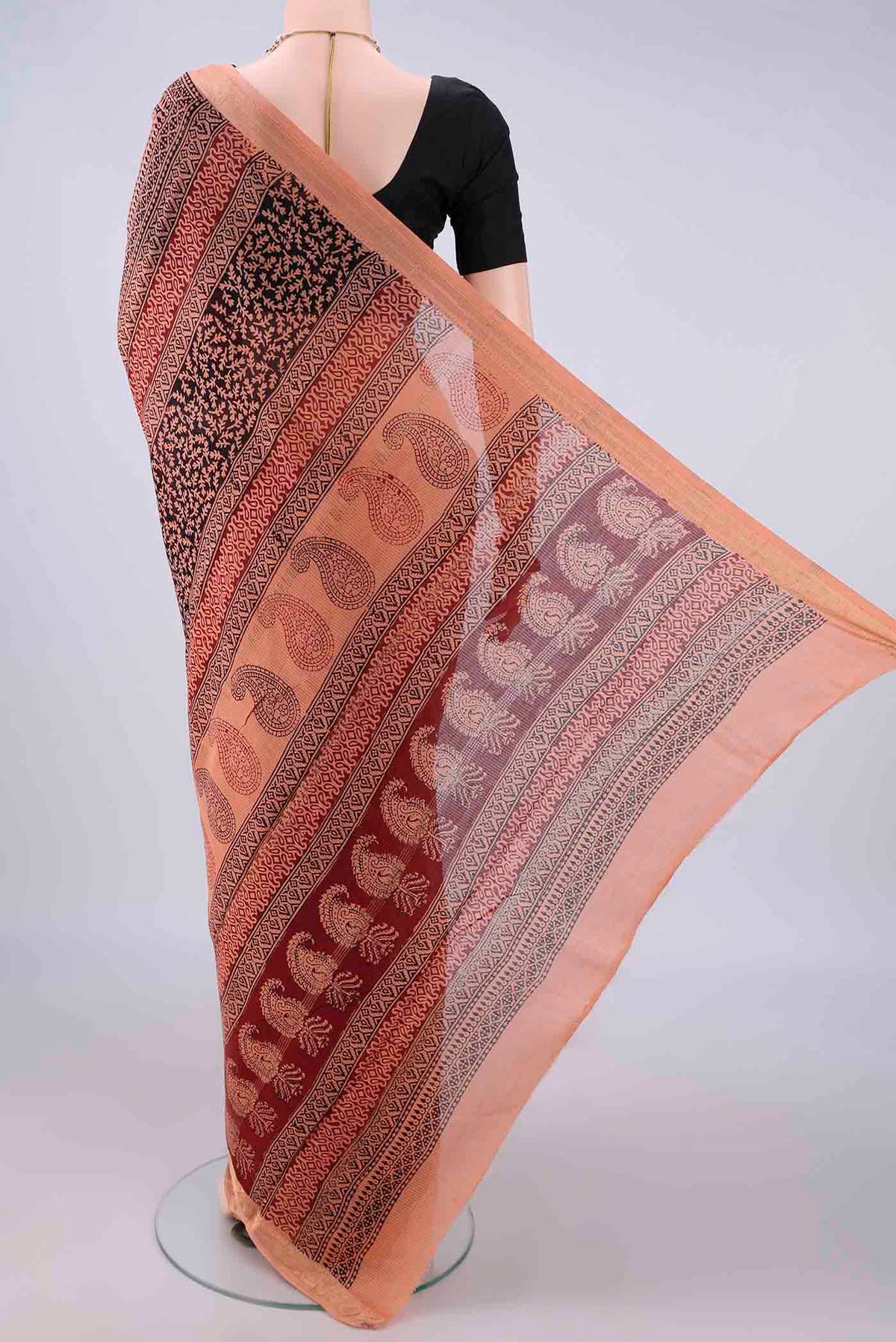 Flat view of Peach Maheshwari Cotton Saree with Printed design on the body and Zari Border. 