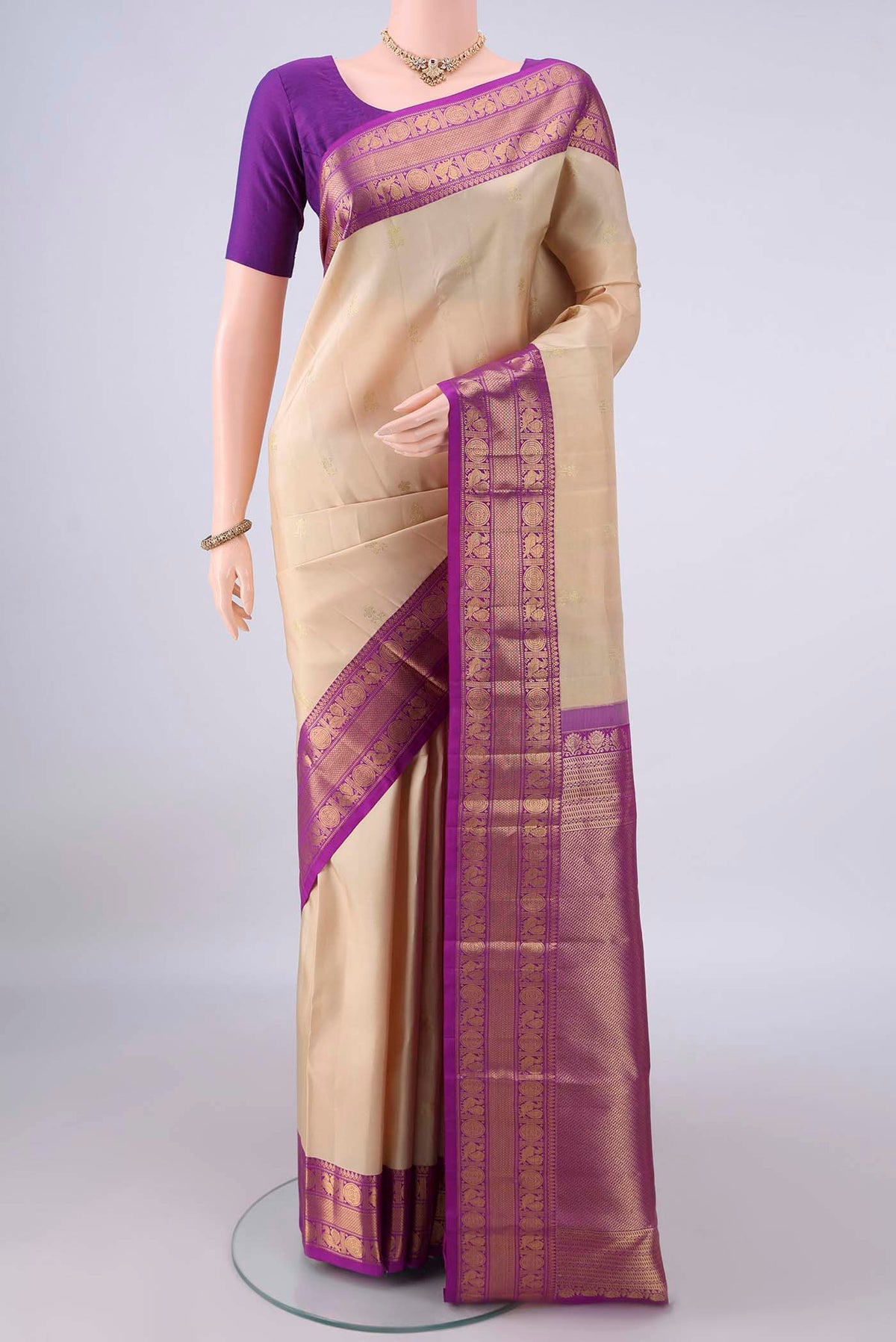 Pure Silk Cream Kanchipuram Saree with Zari Butta on the body and Zari Border.  displayed on a mannequin