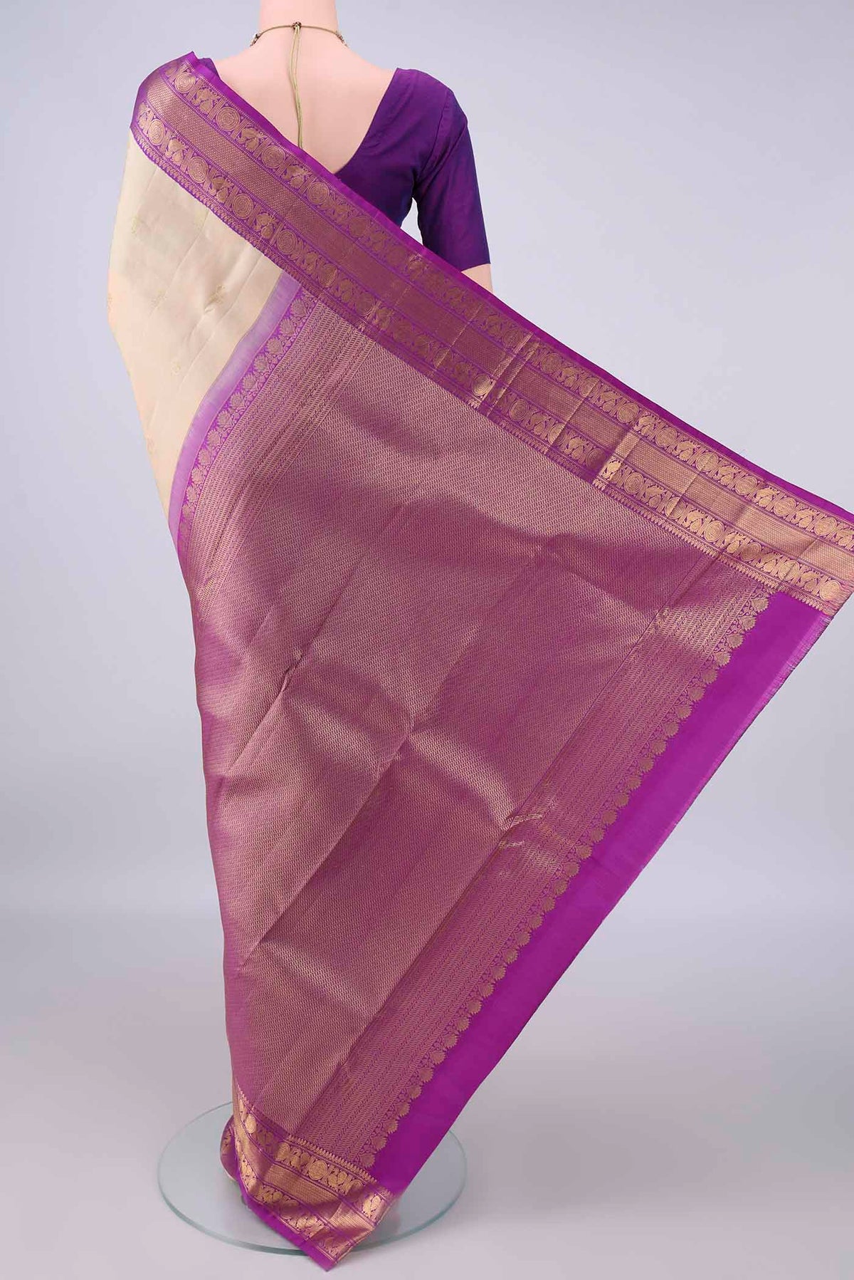 Flat view of Pure Silk Cream Kanchipuram Saree with Zari Butta on the body and Zari Border. 