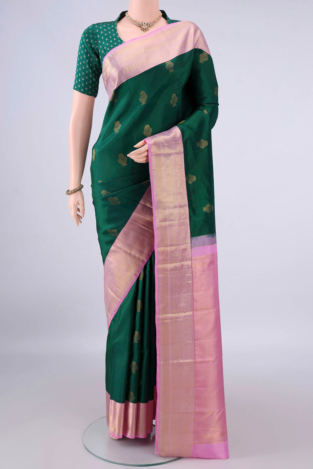 Pure Silk Bottle Green Kanchipuram Saree with Zari Butta on the body and Zari Border.  displayed on a mannequin