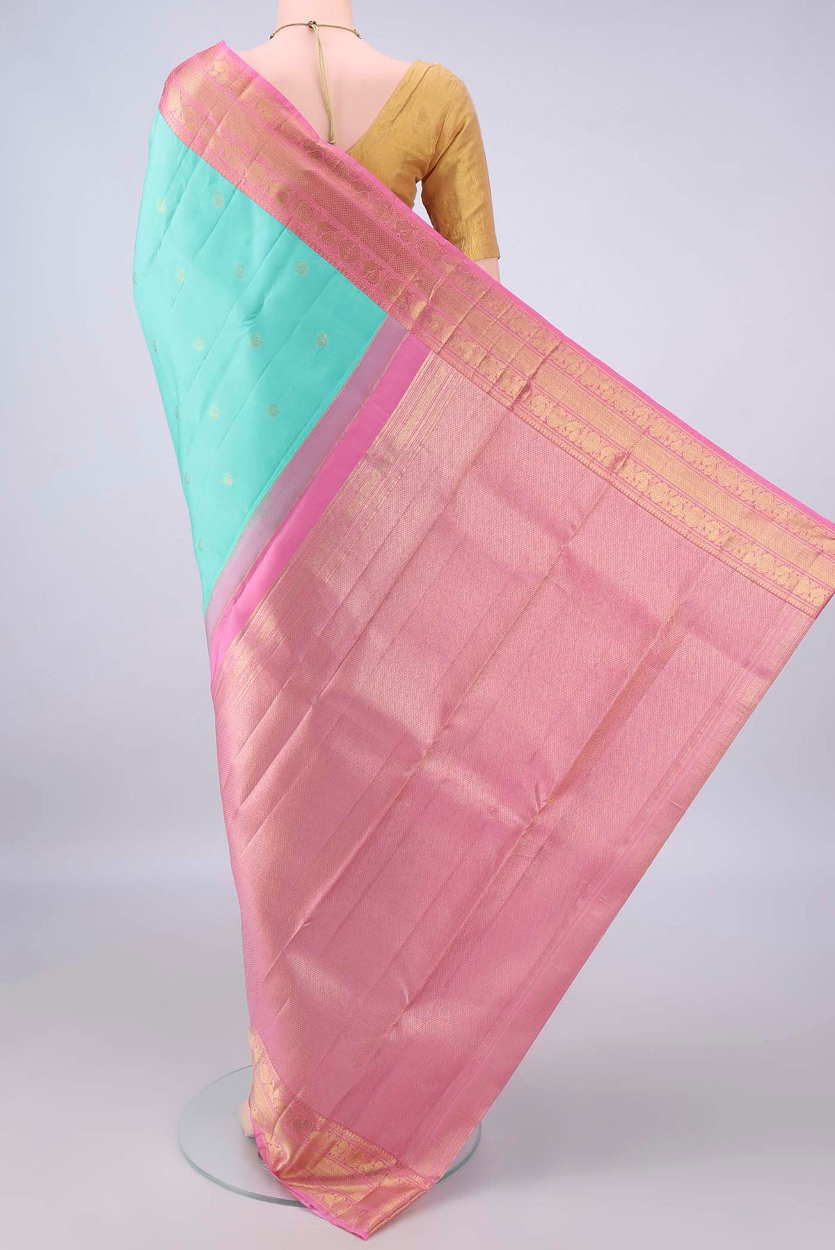 Flat view of Pure Silk Turquoise Kanchipuram Saree with Zari Butta on the body and Zari Border. 