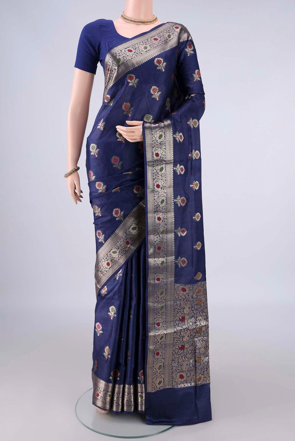 Navy Blue Banarasi Tussar Saree with Zari And Thread Butta on the body and Zari And Thread Border.  displayed on a mannequin