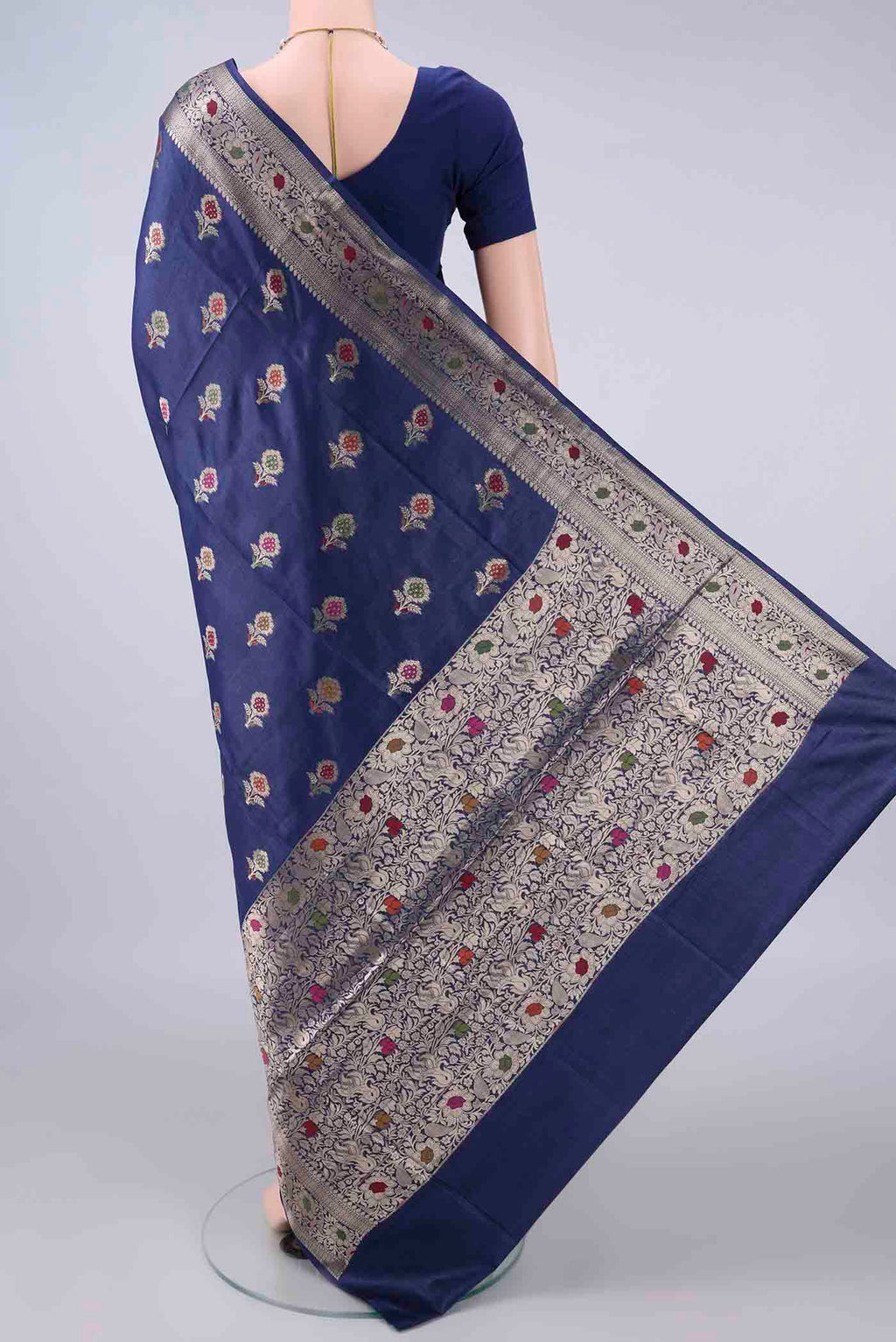 Flat view of Navy Blue Banarasi Tussar Saree with Zari And Thread Butta on the body and Zari And Thread Border. 