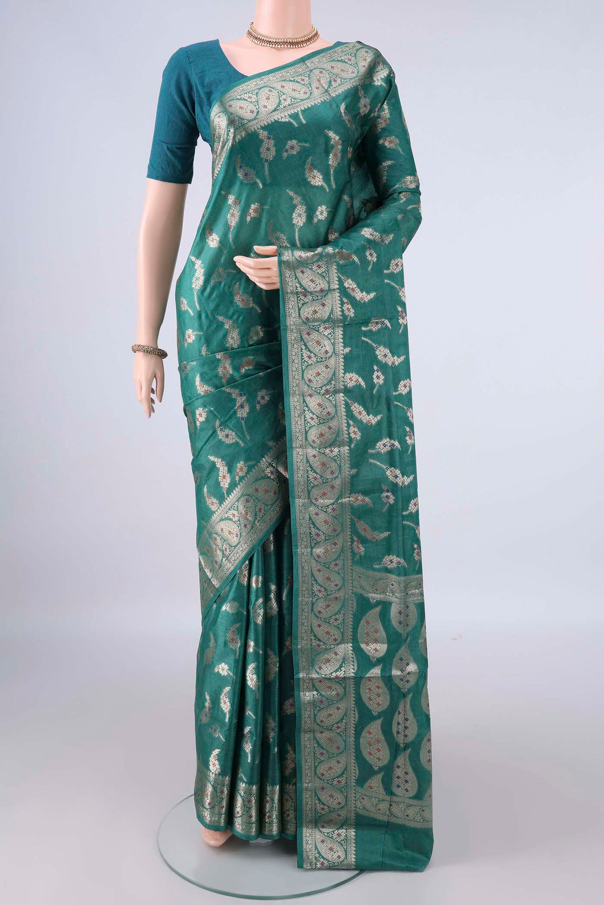 Sea Green Banarasi Tussar Saree with Zari Butta on the body and Zari Border.  displayed on a mannequin