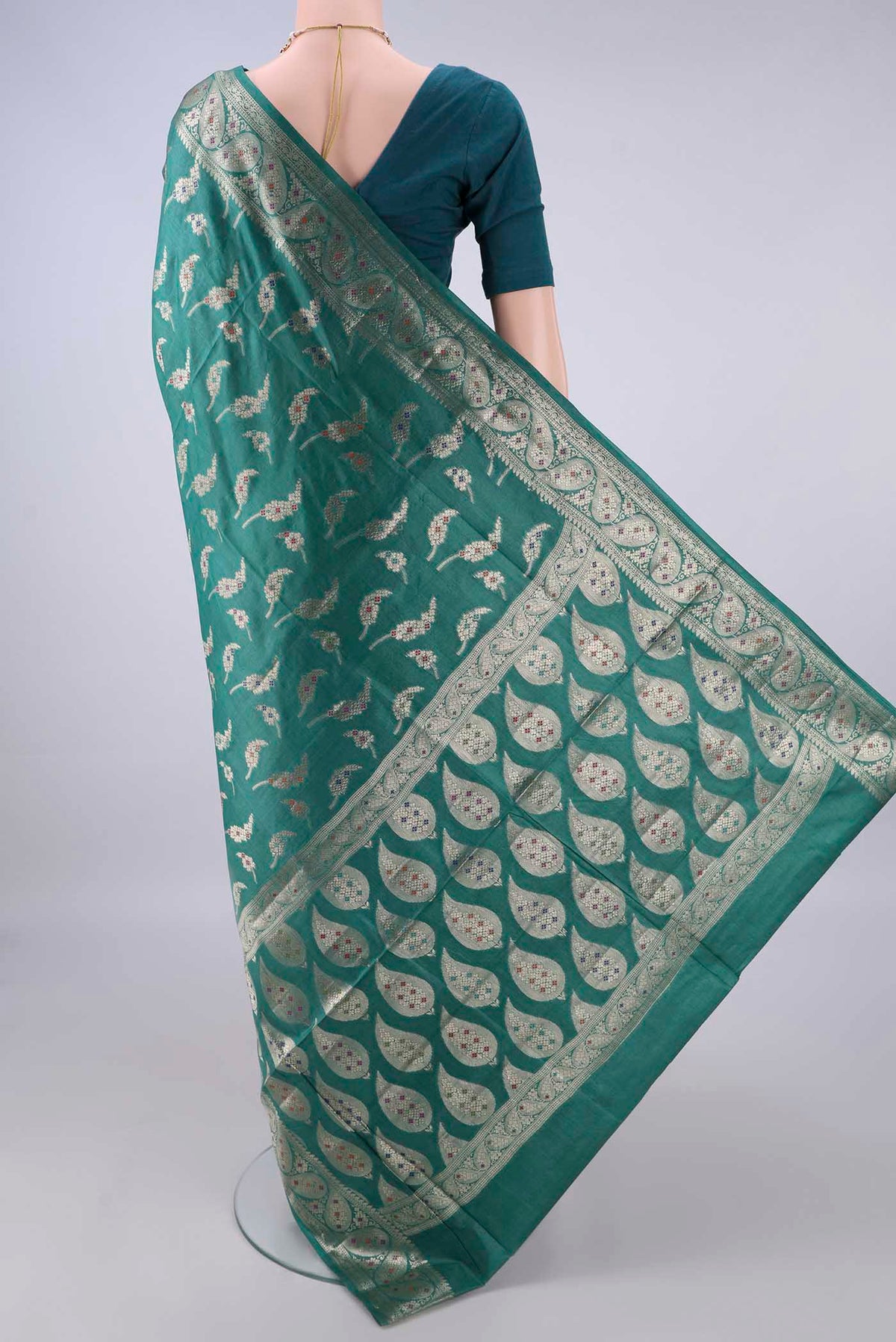 Flat view of Sea Green Banarasi Tussar Saree with Zari Butta on the body and Zari Border. 