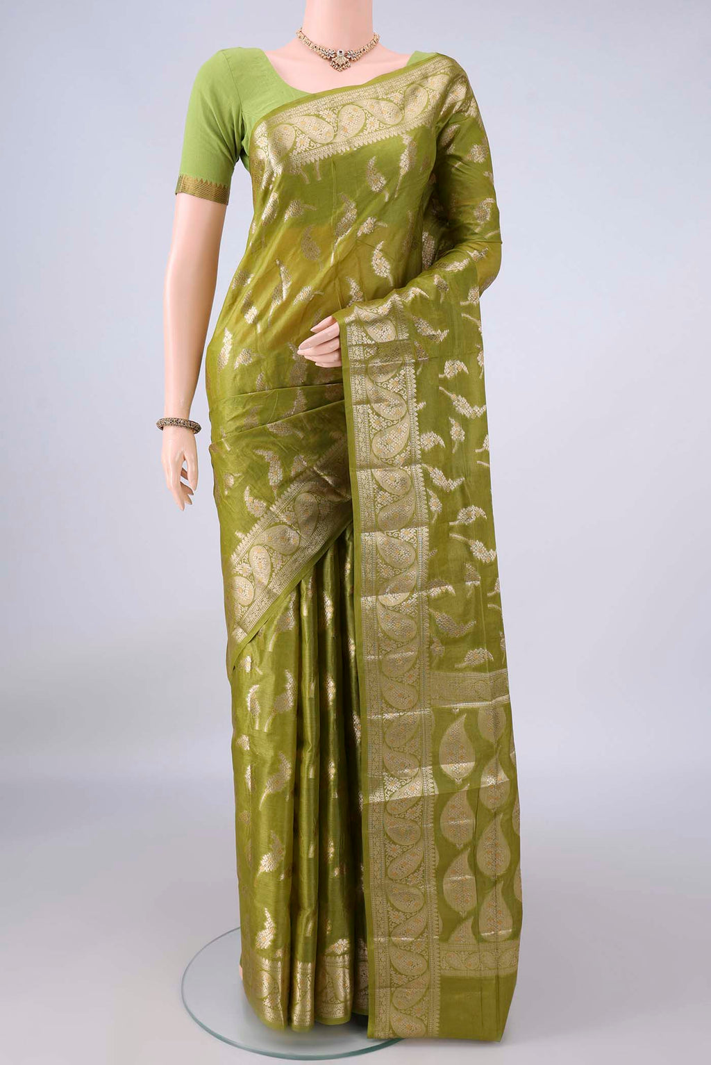 Mehandi Green Banarasi Tussar Saree with Zari Butta on the body and Zari Border.  displayed on a mannequin