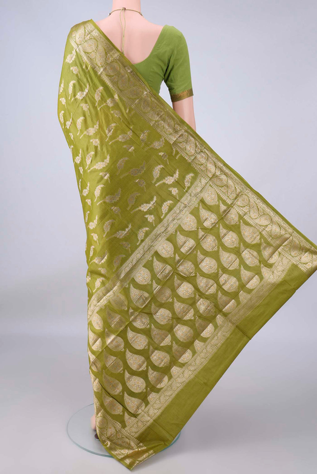 Flat view of Mehandi Green Banarasi Tussar Saree with Zari Butta on the body and Zari Border. 