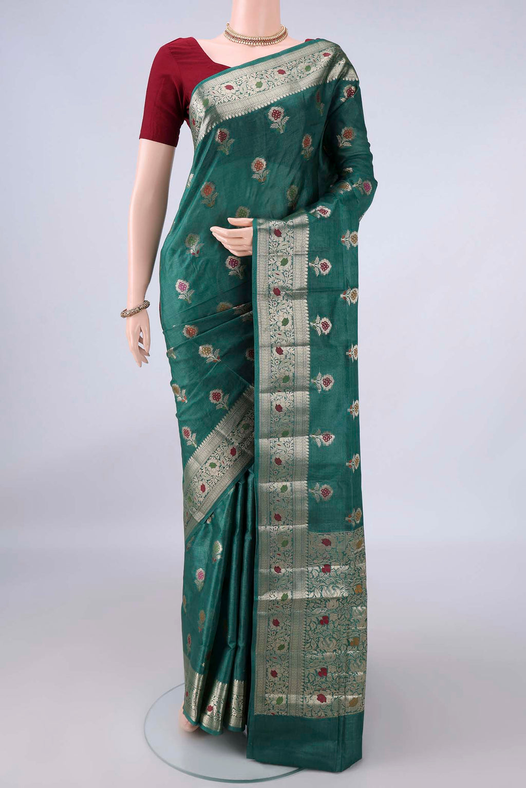 Green Banarasi Tussar Saree with Zari And Thread Butta on the body and Zari And Thread Border.  displayed on a mannequin