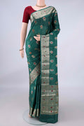 Green Banarasi Tussar Saree with Zari And Thread Butta on the body and Zari And Thread Border.  displayed on a mannequin