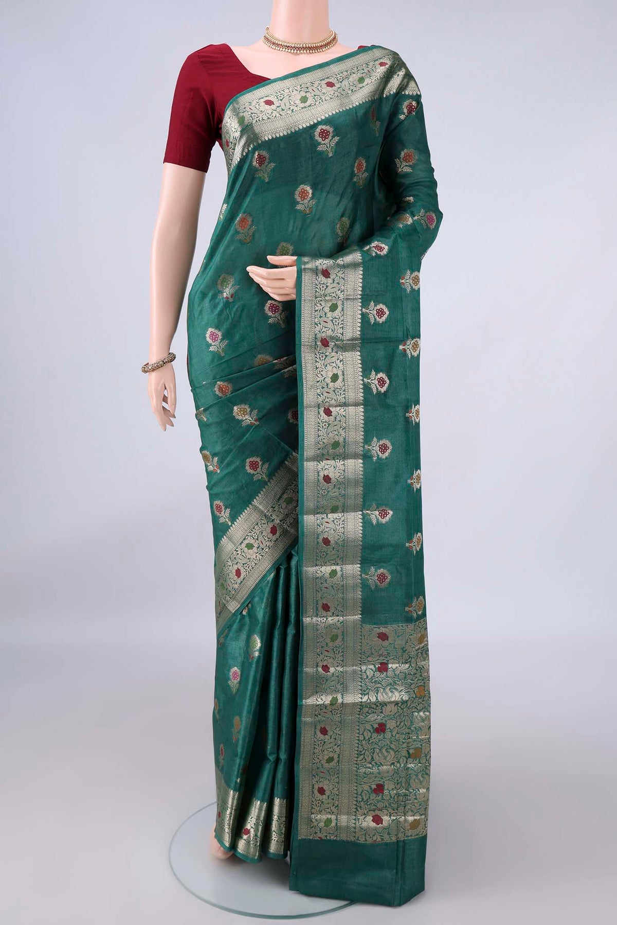 Green Banarasi Tussar Saree with Zari And Thread Butta on the body and Zari And Thread Border.  displayed on a mannequin