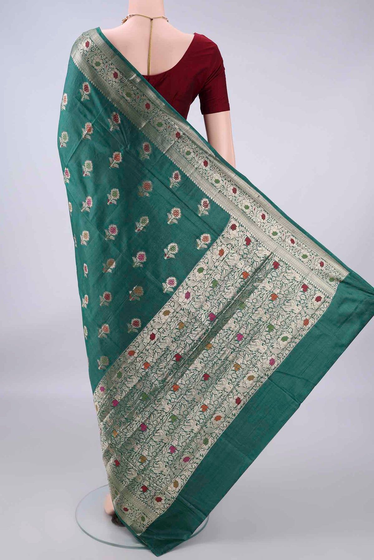 Flat view of Green Banarasi Tussar Saree with Zari And Thread Butta on the body and Zari And Thread Border. 