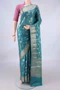 Green Banarasi Raw Saree with Zari And Thread Butta on the body and Zari And Thread Border.  displayed on a mannequin