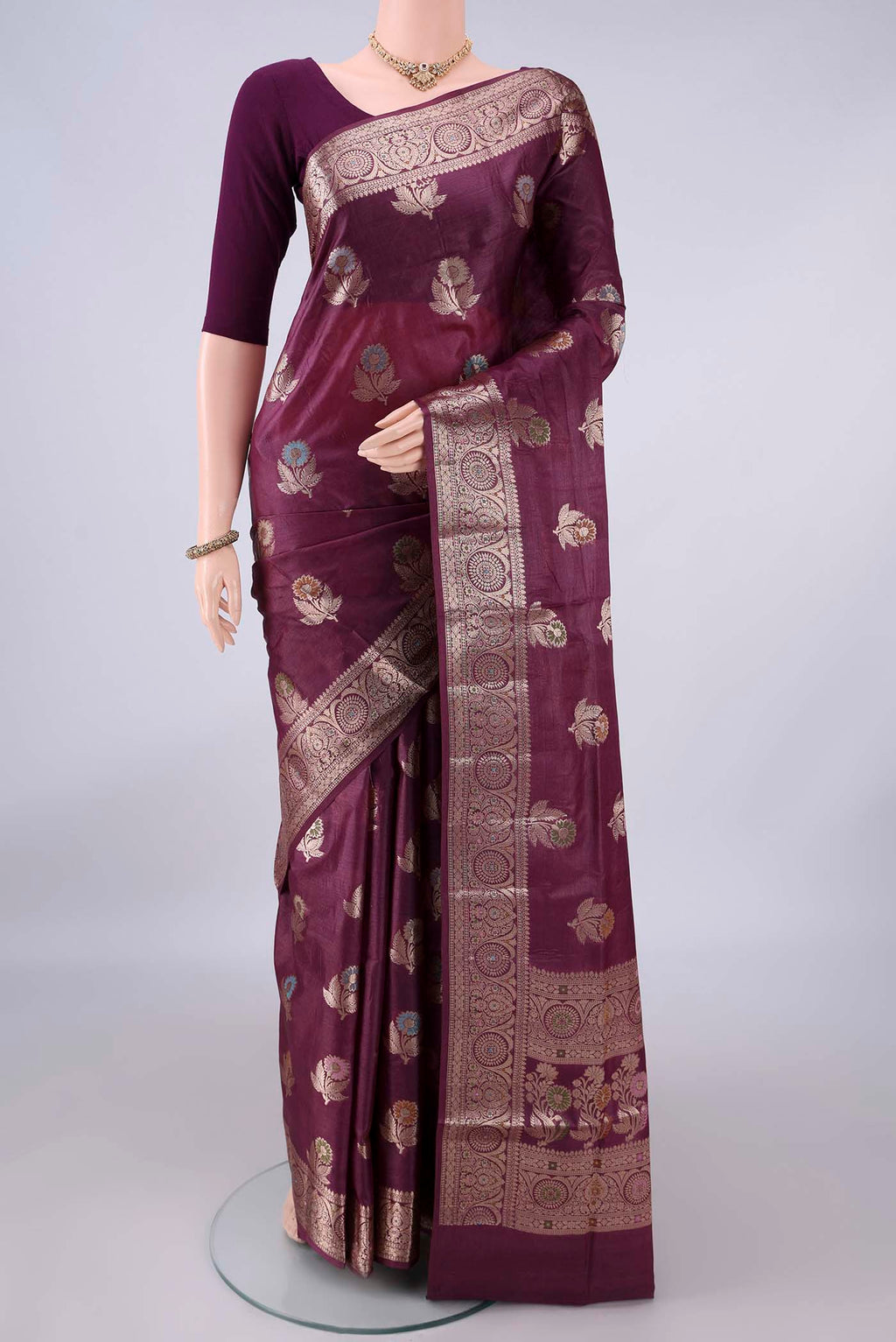 Burgundy Banarasi Tussar Saree with Zari Butta on the body and Zari And Thread Border.  displayed on a mannequin