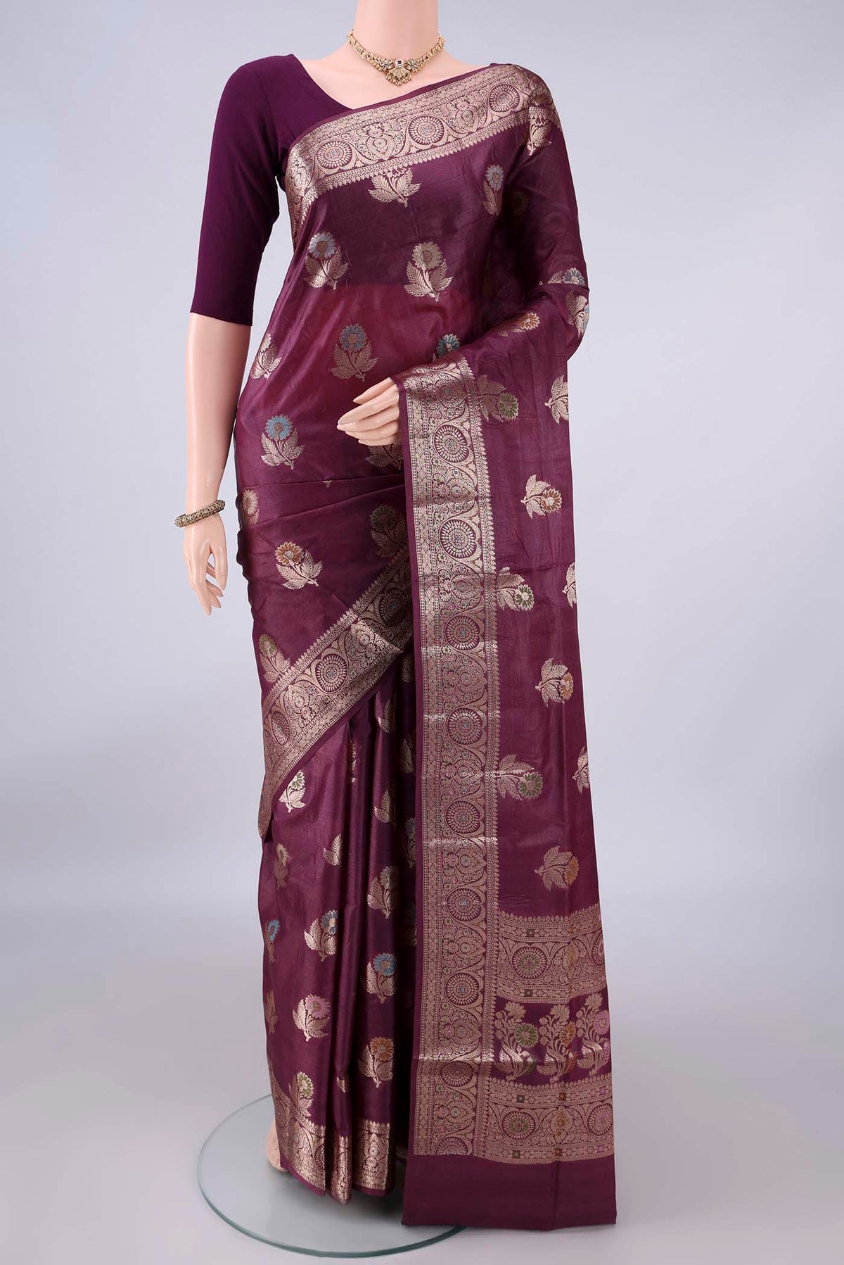 Burgundy Banarasi Tussar Saree with Zari Butta on the body and Zari And Thread Border.  displayed on a mannequin