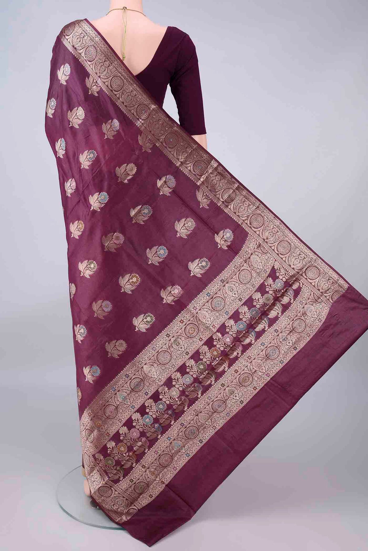 Flat view of Burgundy Banarasi Tussar Saree with Zari Butta on the body and Zari And Thread Border. 