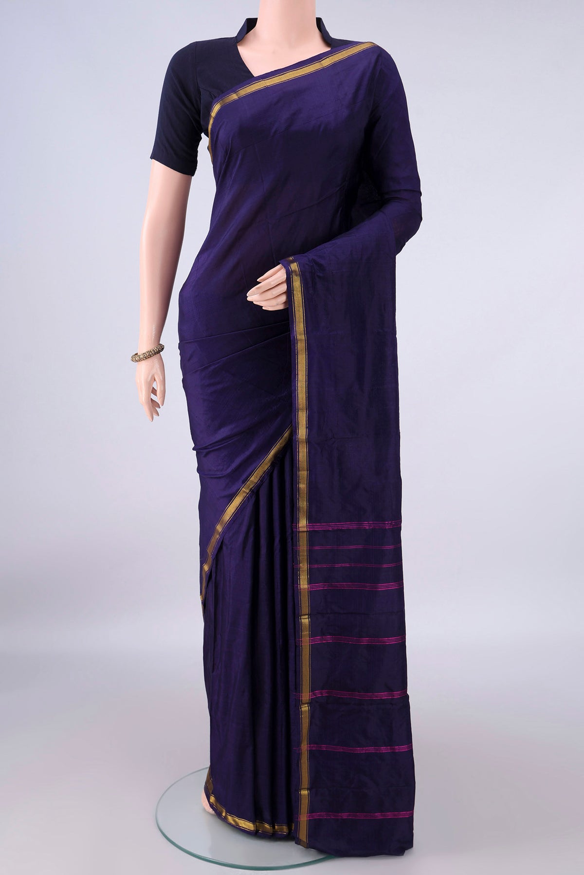 Pure Silk Navy Blue Kanchipuram Saree with Plain Body and Zari Border.  displayed on a mannequin