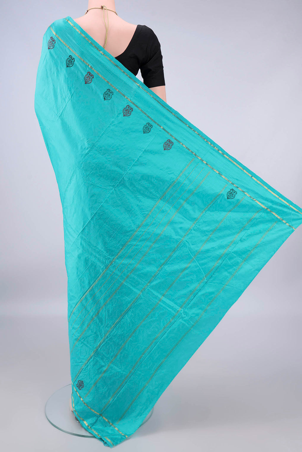 Flat view of Pure Silk Turquoise Kanchipuram Saree with Plain Body and Zari Border. 