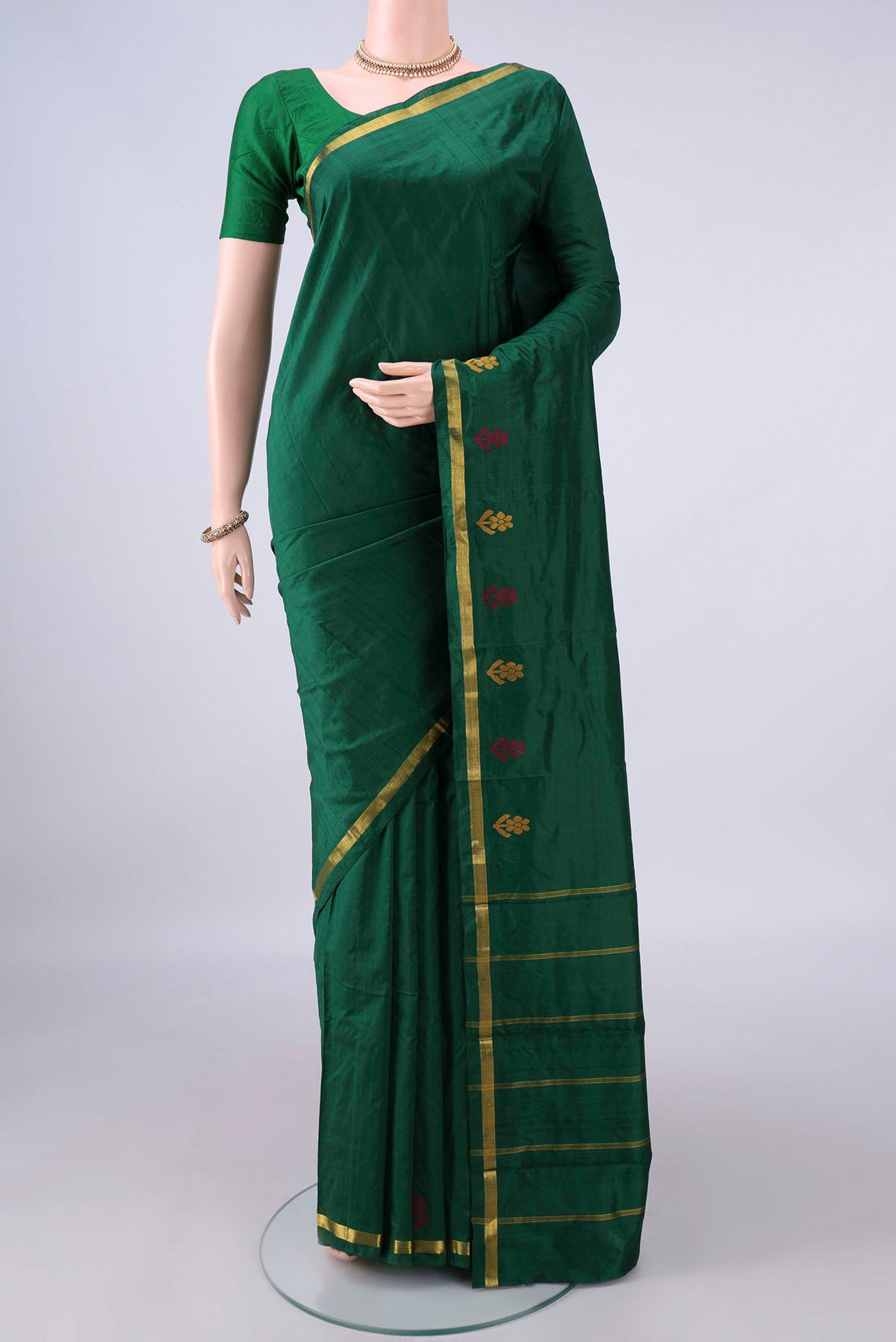 Pure Silk Bottle Green Kanchipuram Saree with Plain Body and Zari Border.  displayed on a mannequin
