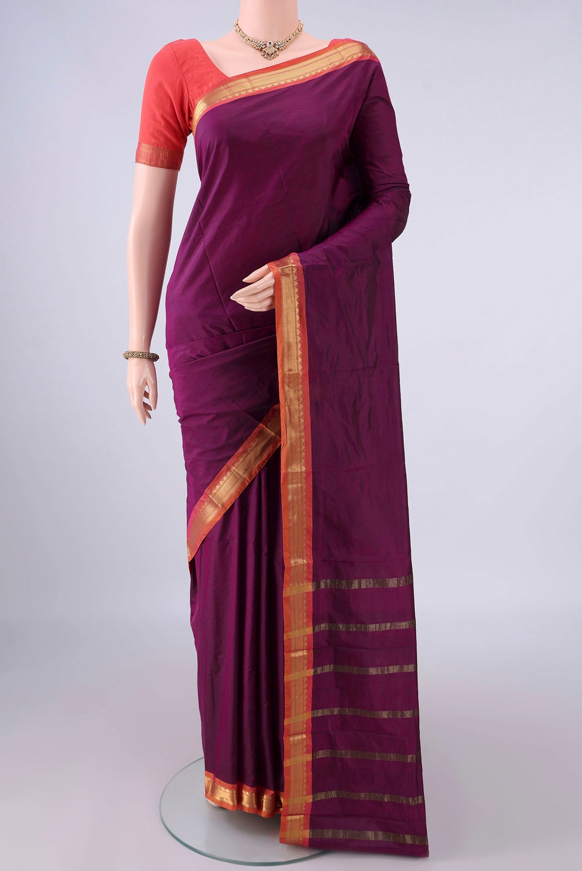 Magenta Blended Bangalore Silk Saree with Plain Body and Zari Border.  displayed on a mannequin