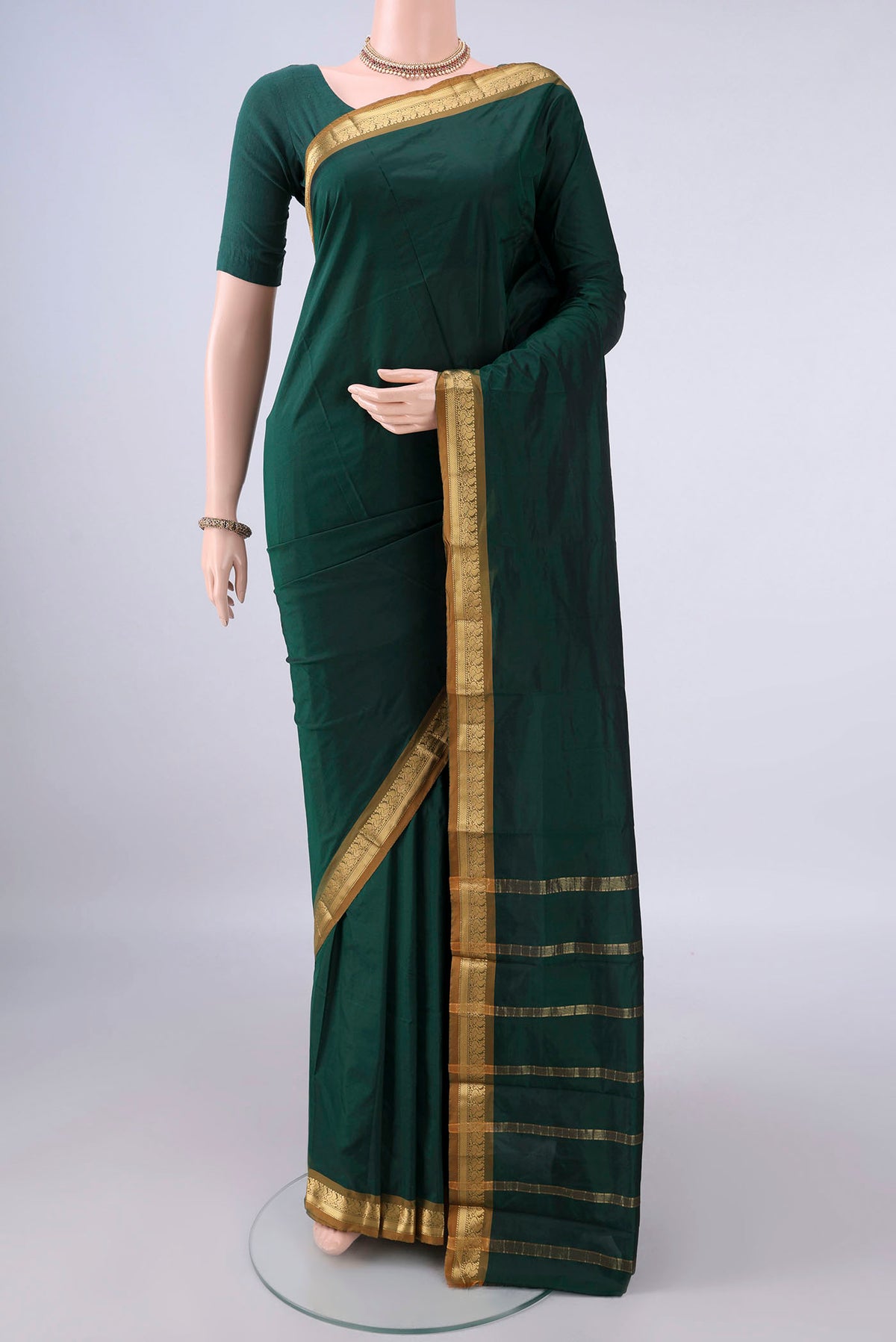 Bottle Green Blended Bangalore Silk Saree with Plain Body and Zari Border.  displayed on a mannequin