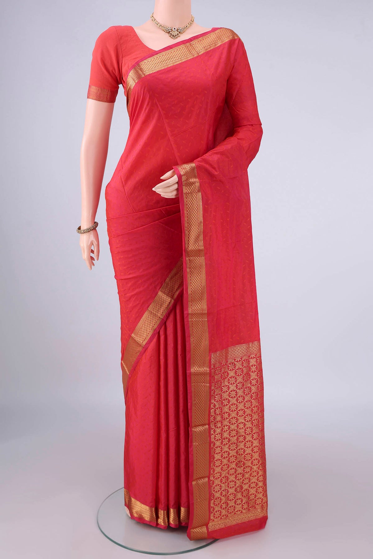Brick Orange Blended Bangalore Silk Saree with Jacquard design on the body and Zari Border.  displayed on a mannequin