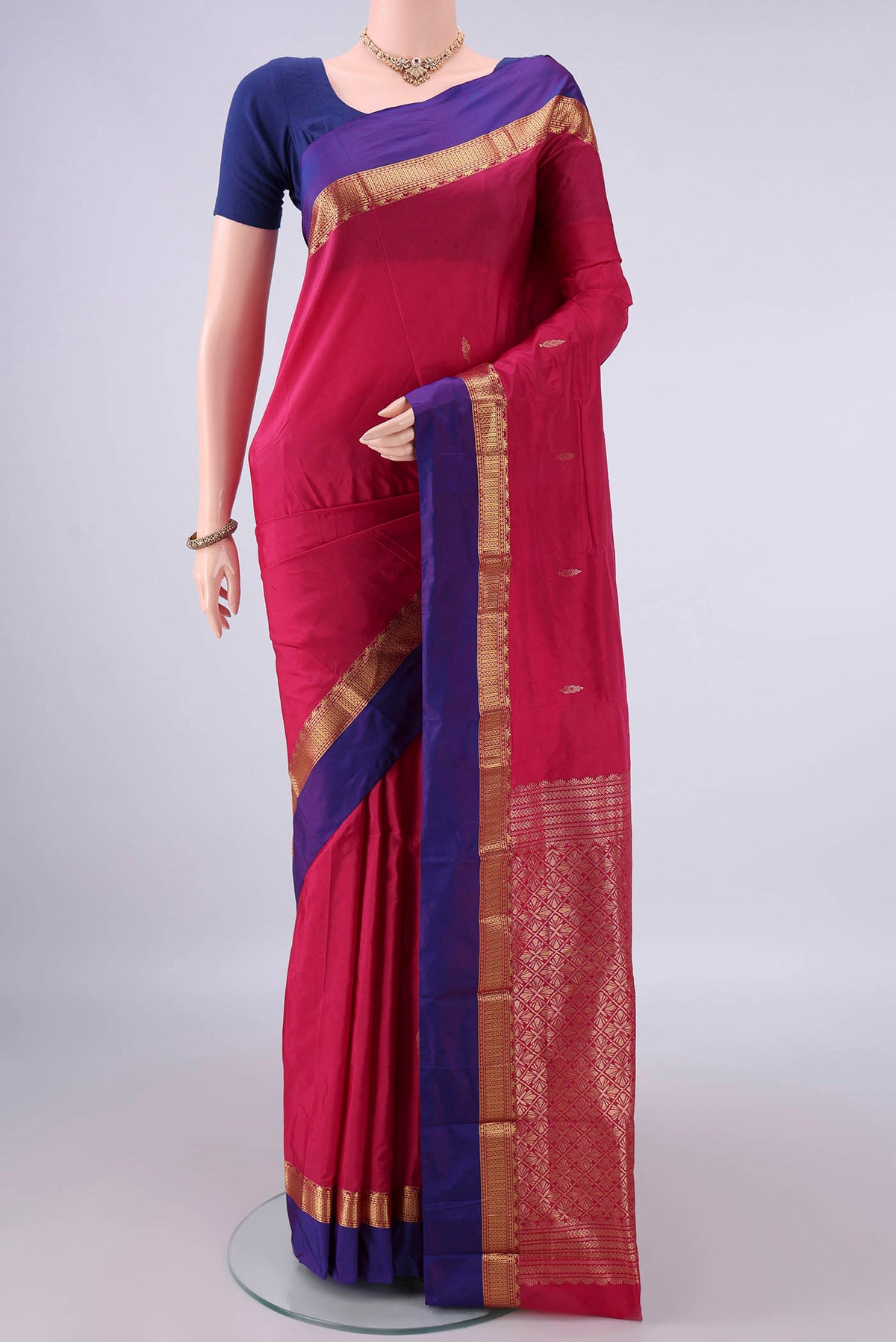 Rani Pink Blended Bangalore Silk Saree with Zari Butta on the body and Zari Border.  displayed on a mannequin