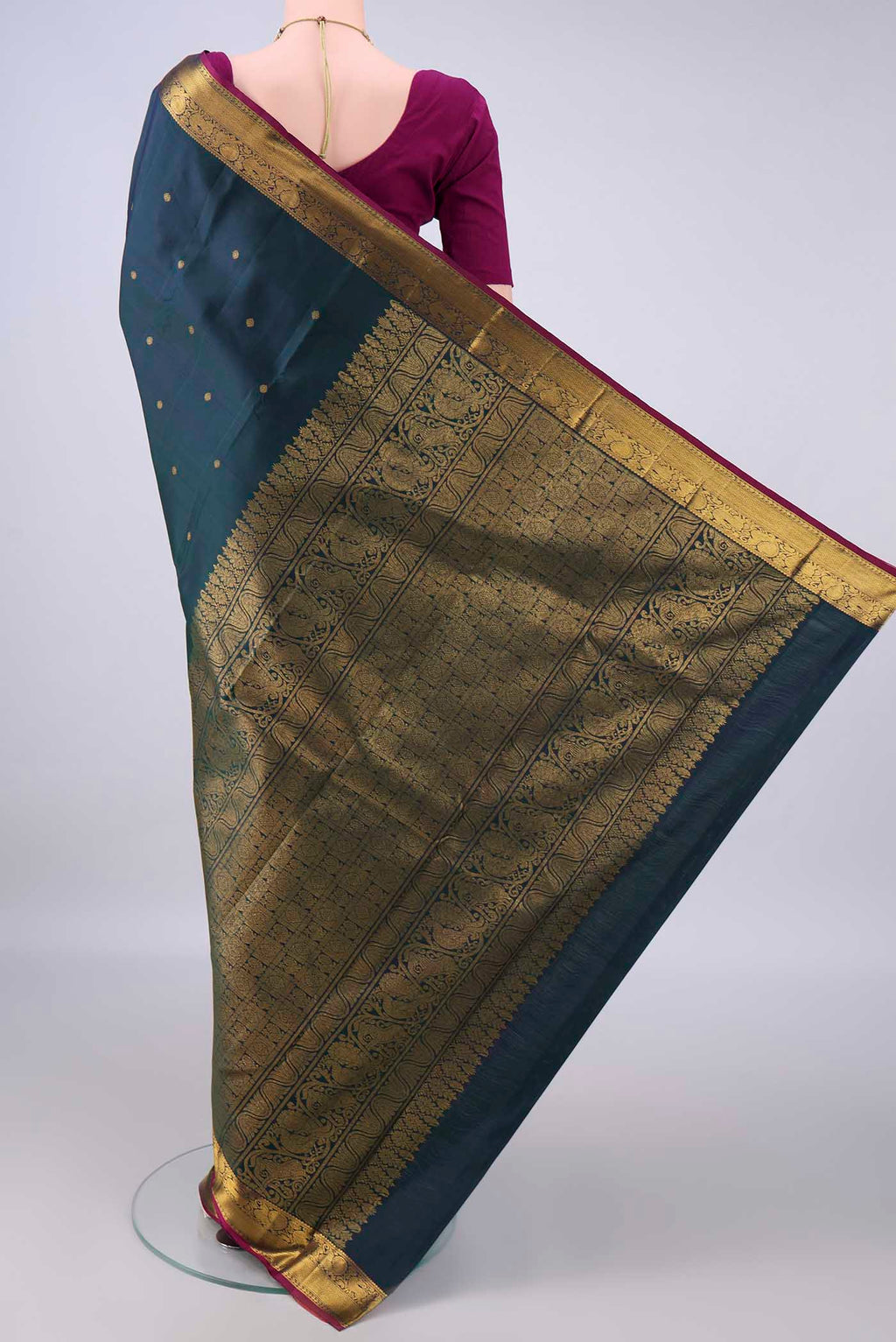 Flat view of Pure Silk Bottle Green Dual Tone Kanchipuram Saree with Zari Butta on the body and Zari Border. 