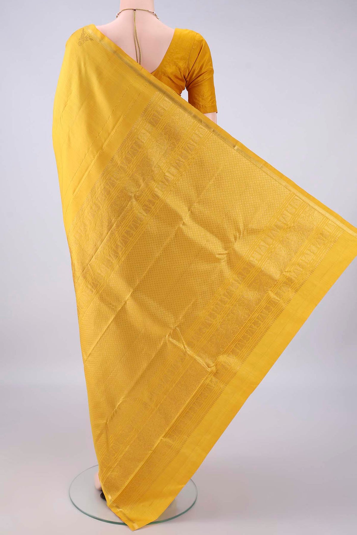 Flat view of Pure Silk Yellow Kanchipuram Saree with Plain Body and Zari Border. 