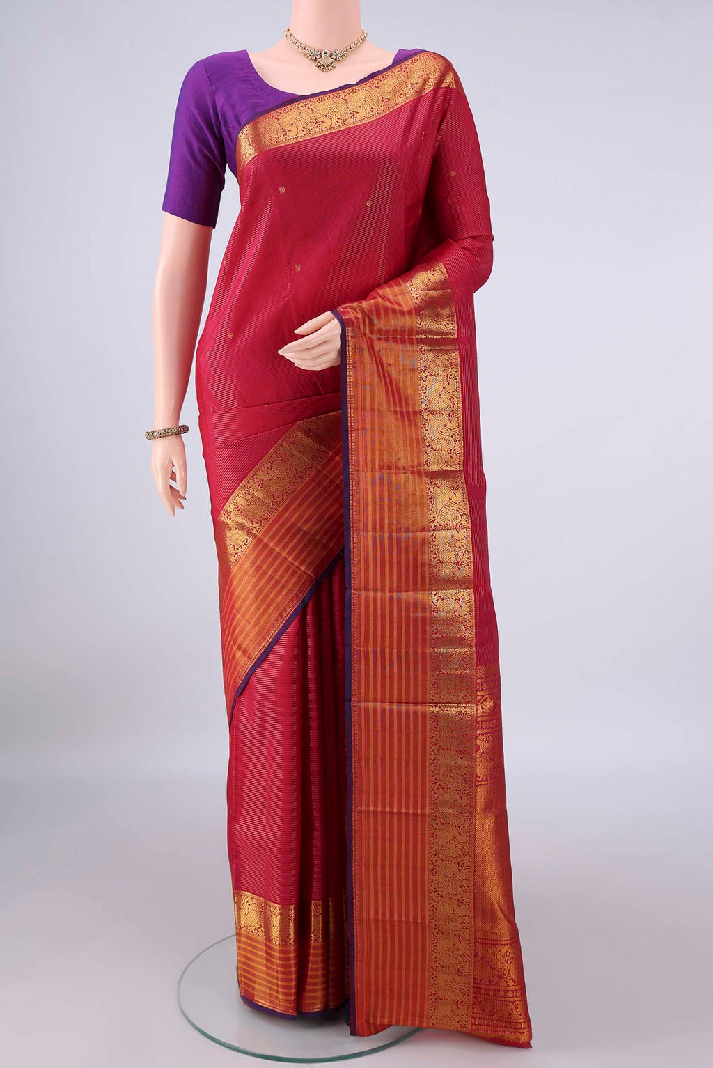 Pure Silk Red Kanjivaram Saree with Zari Butta on the body and Zari Border.  displayed on a mannequin