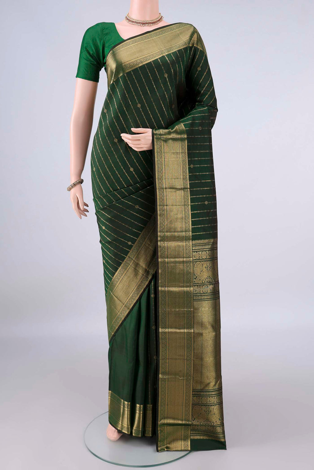 Pure Silk Bottle Green Kanchipuram Saree with Stripes on the body and Zari Border.  displayed on a mannequin