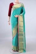 Pure Silk Turquoise Kanjivaram Saree with Zari Butta on the body and Zari Border.  displayed on a mannequin