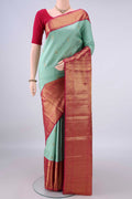 Pure Silk Mint Green Kanjivaram Saree with Zari Butta on the body and Zari Border.  displayed on a mannequin