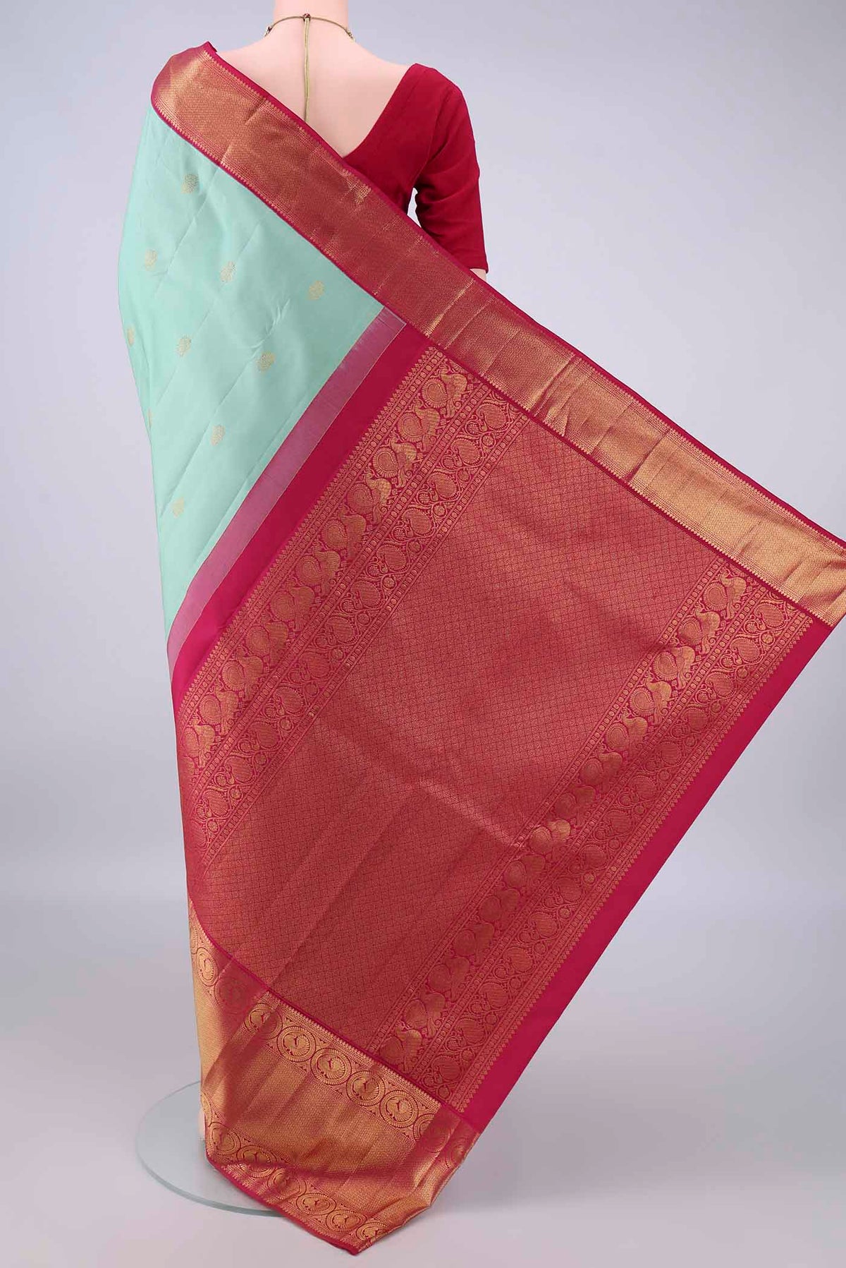 Flat view of Pure Silk Mint Green Kanjivaram Saree with Zari Butta on the body and Zari Border. 