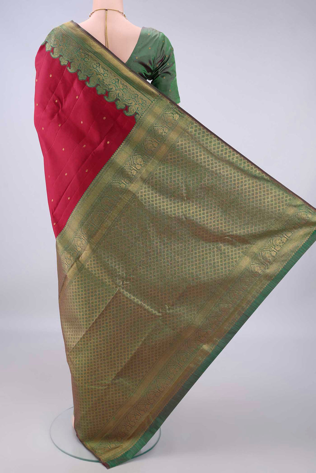 Flat view of Pure Silk Deep Red Kanjivaram Saree with Zari Butta on the body and Zari Border. 