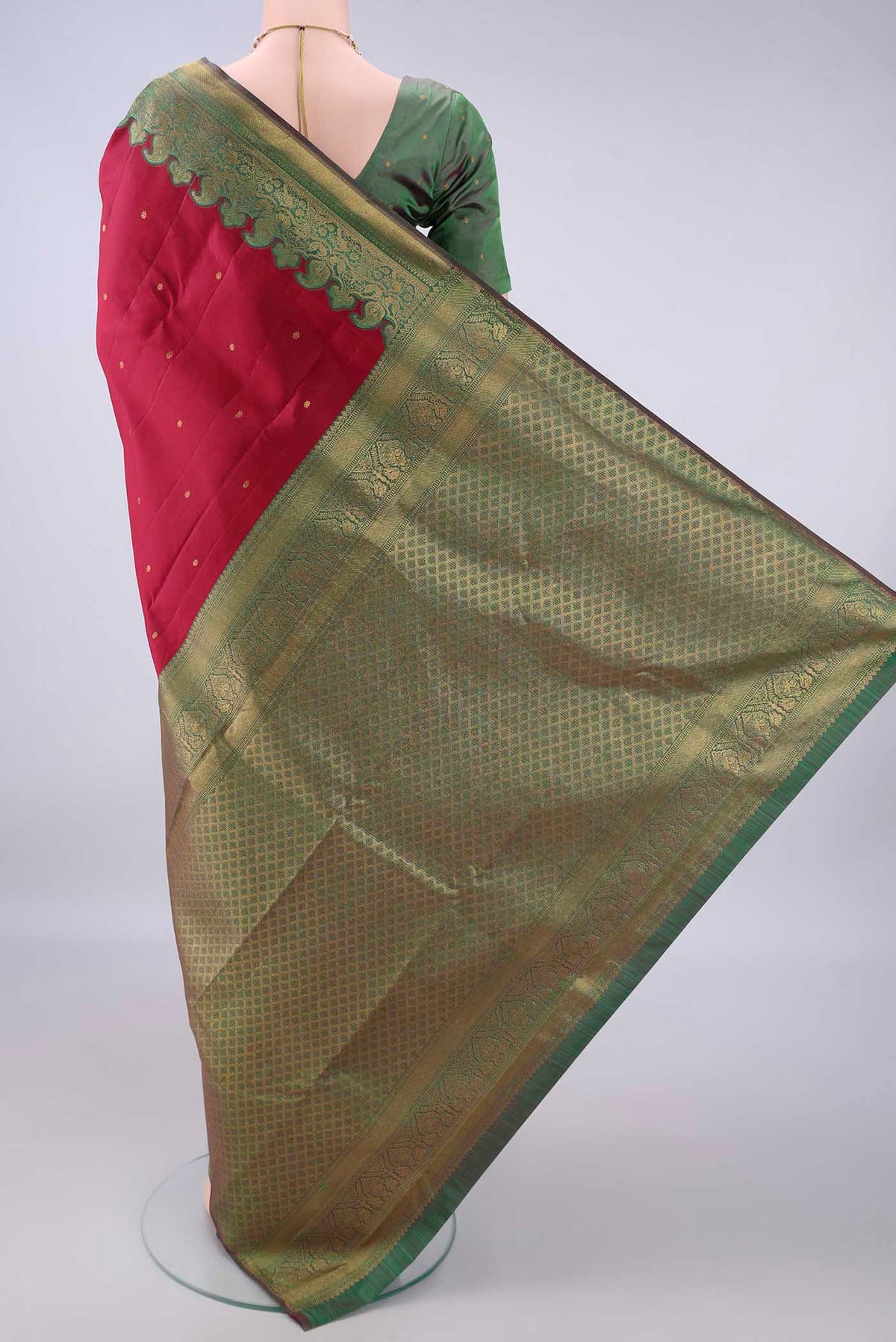 Flat view of Pure Silk Deep Red Kanjivaram Saree with Zari Butta on the body and Zari Border. 