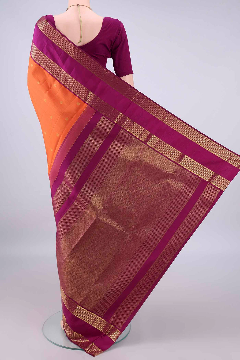 Flat view of Pure Silk Orange Kanjivaram Saree with Zari Butta on the body and Zari Border. 