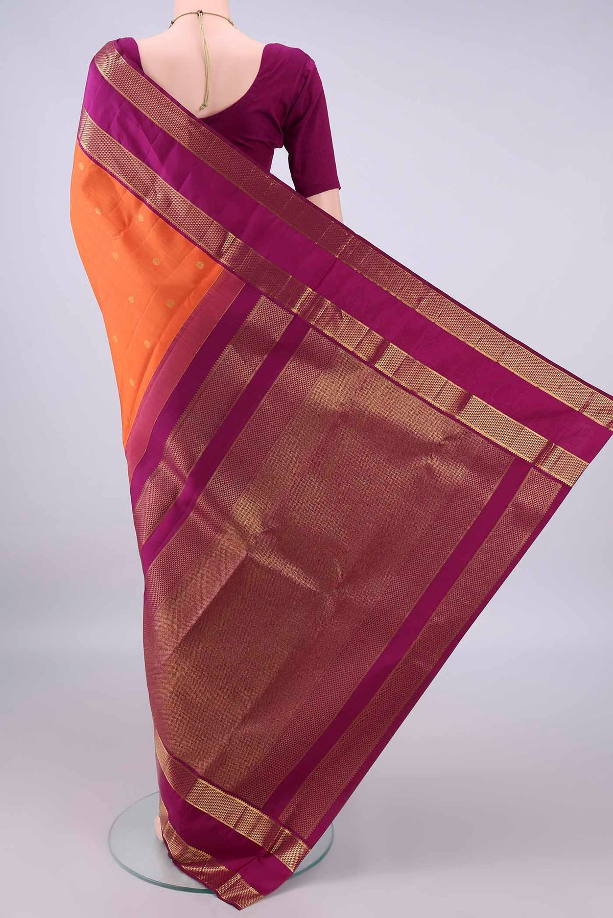 Flat view of Pure Silk Orange Kanjivaram Saree with Zari Butta on the body and Zari Border. 
