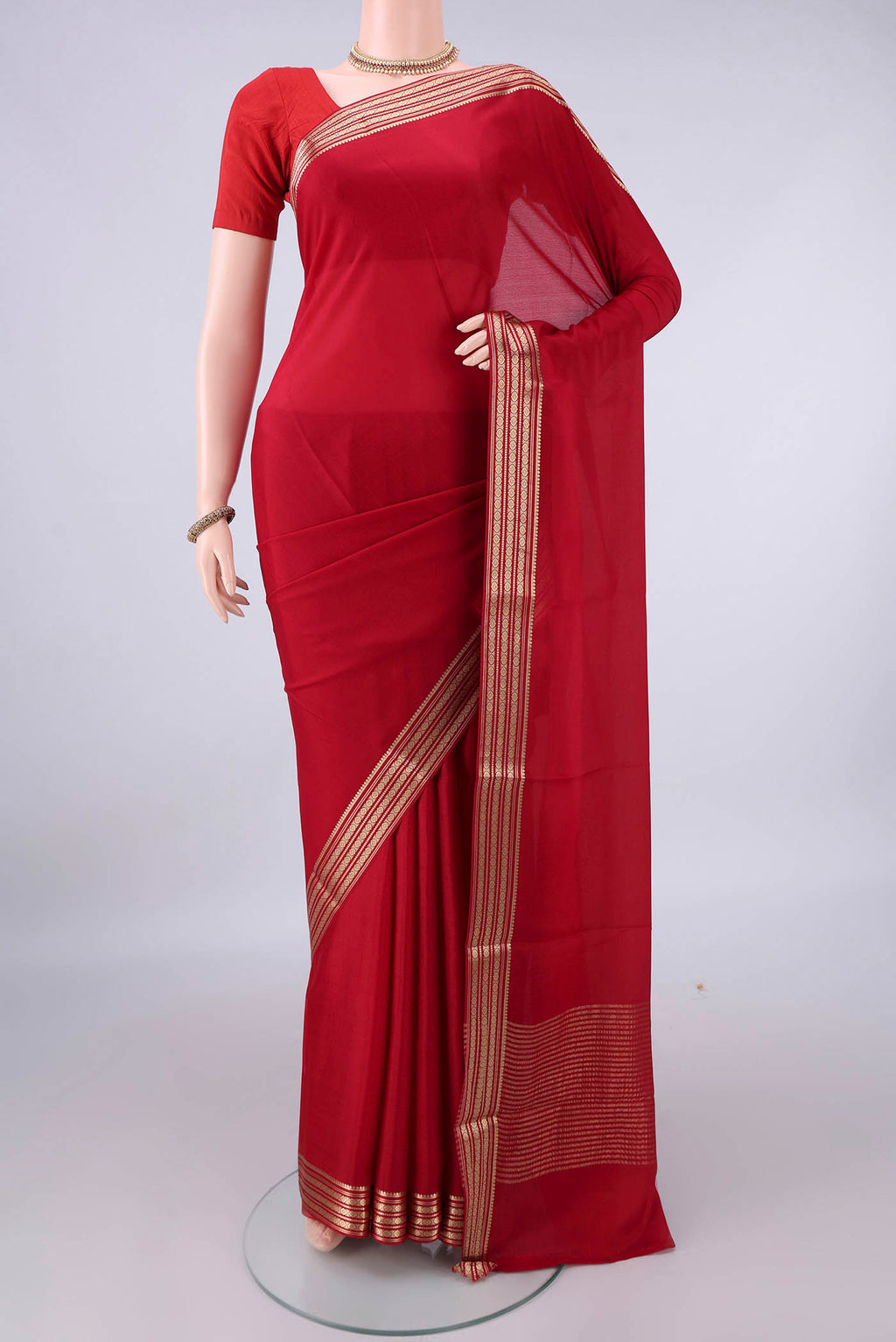 Red Mysore Crepe Saree with Plain Body and Zari Border.  displayed on a mannequin