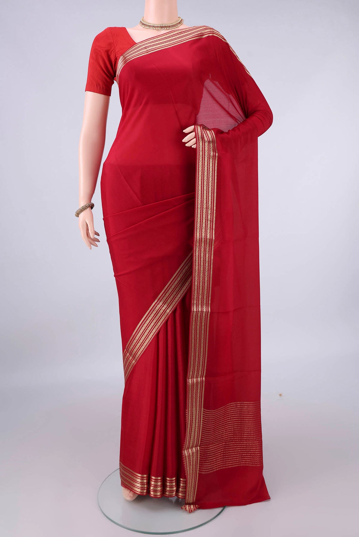 Red Mysore Crepe Saree with Plain Body and Zari Border.  displayed on a mannequin