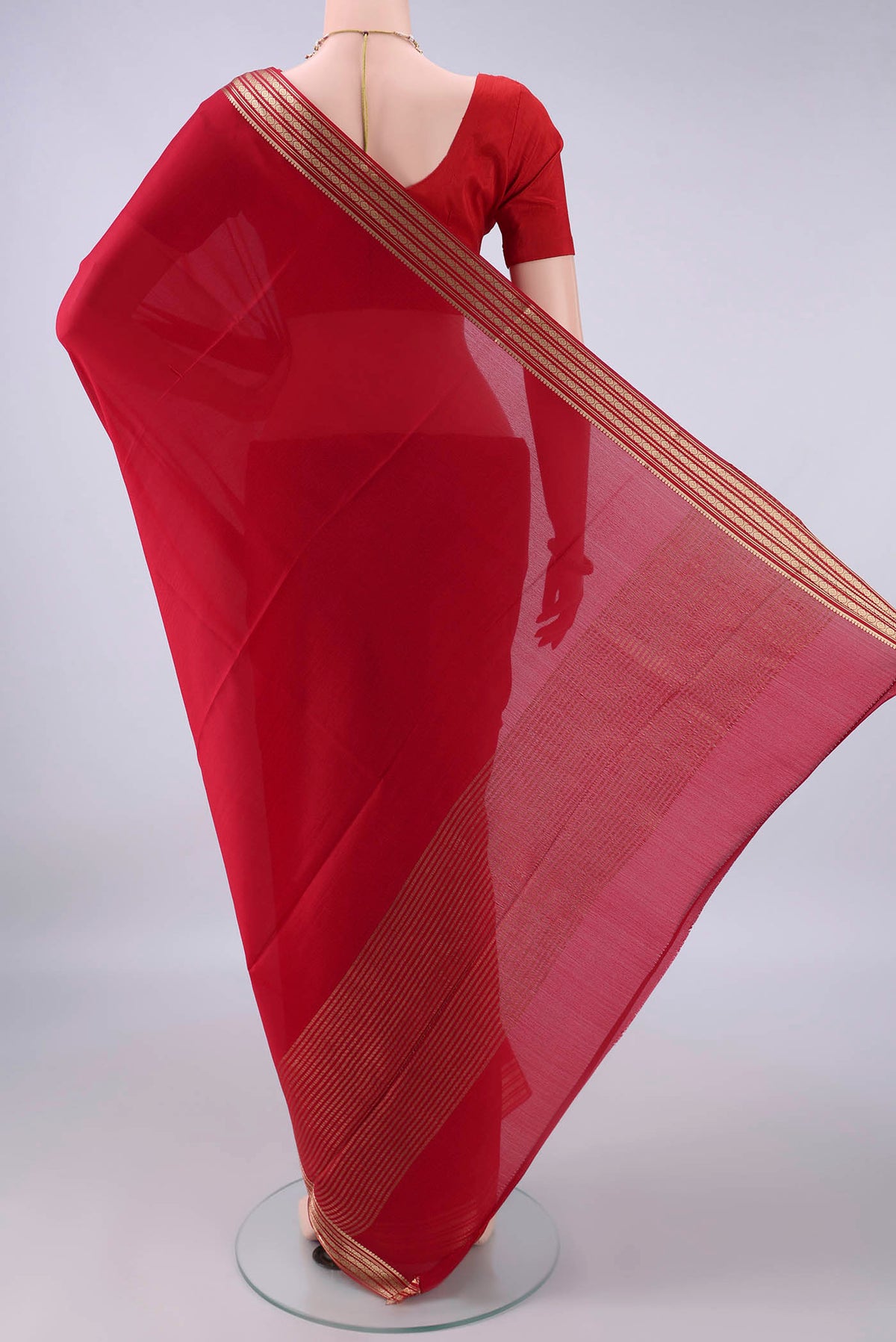Flat view of Red Mysore Crepe Saree with Plain Body and Zari Border. 