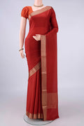 Rust Mysore Crepe Saree with Plain Body and Zari Border.  displayed on a mannequin