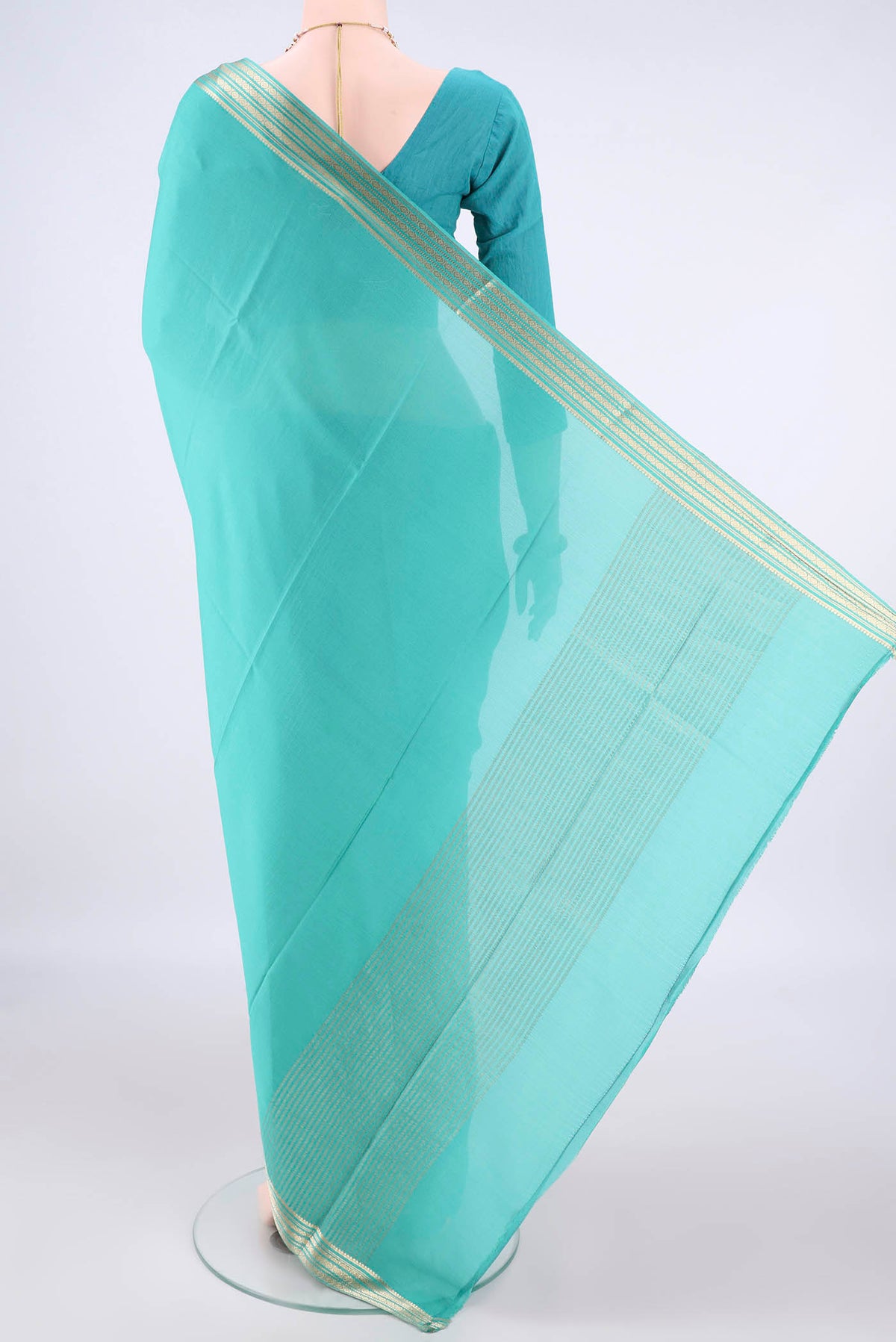 Flat view of Turquoise Mysore Crepe Saree with Plain Body and Zari Border. 